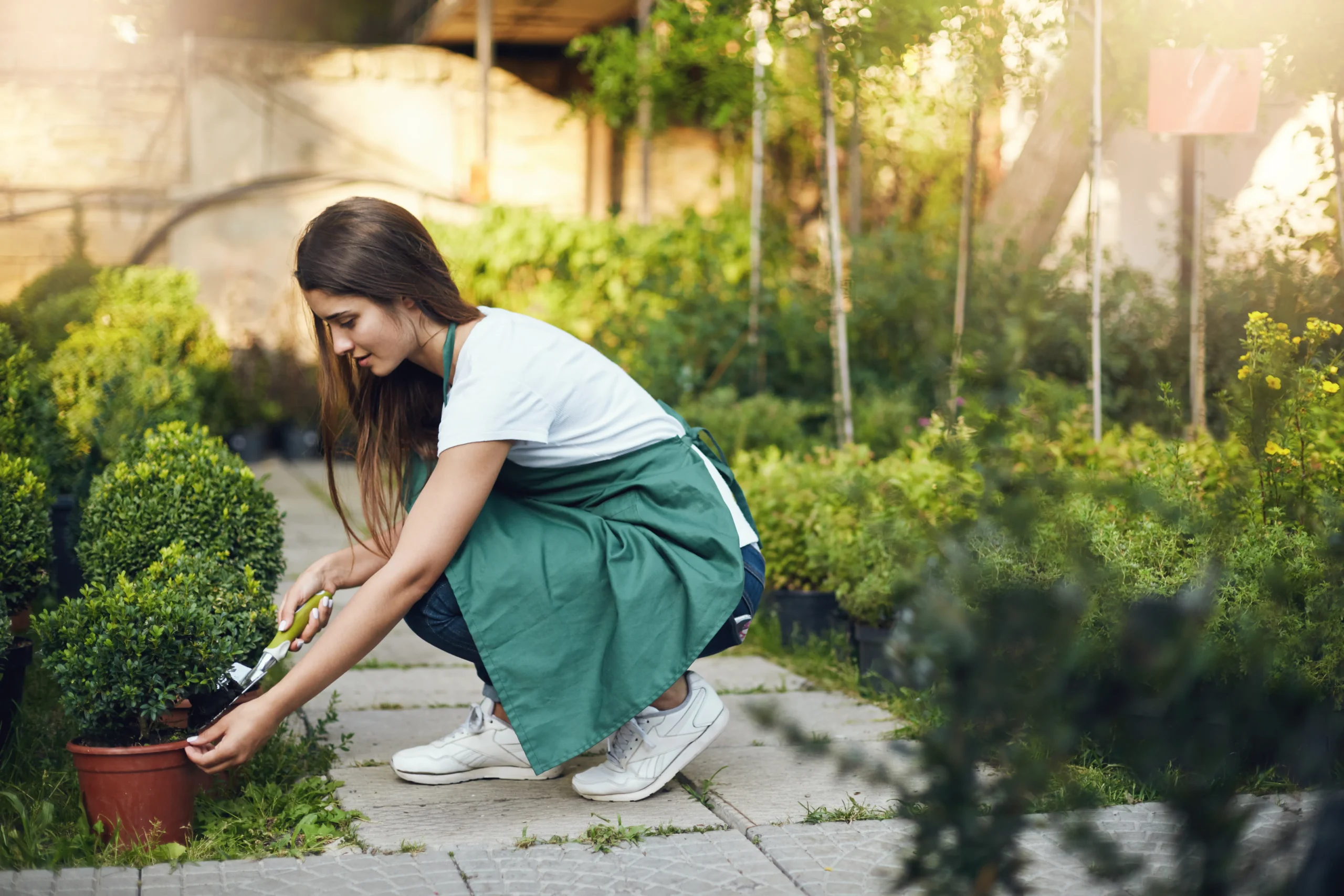 young-chic-female-gardener-taking-care-plants-backyard-earning-money-pursue-her-travel-dream-young-employee-concept